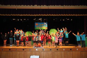 students on stage posing after a dance