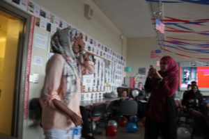 Razan closes her eyes as she enters the room to be surprised by her classmates