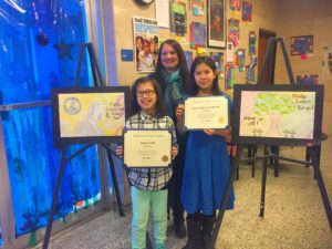 Satya Groff, art teacher Joanne Woitkoski and Irene Nguyen-McDowell and their artwork.