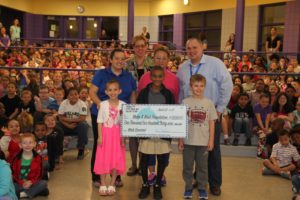 Students, adults and Iliana hold giant make-a-wish check.