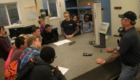 Students standing around a table learning about Simmons Machine Tool