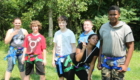 Students in harnesses smile for the camera