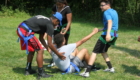 Students helping another student up off the ground
