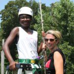 Female student and teacher getting ready for ropes course at HVCC