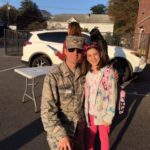 Dad in military uniform and young daughter