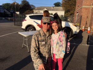 Dad in military uniform and young daughter