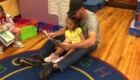 Dad reading to young daughter