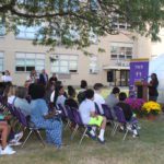 Crowd looks on as student Anya Burke speaks