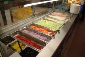 Photo of the Deli at Troy High School. Items include lunch meat, cheese, and various vegetables.