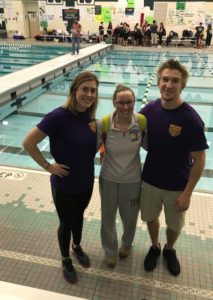 female swimmer with two coaches