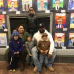 Students standing in front of their artwork.