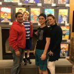 Students standing in front of their artwork.
