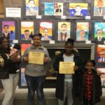 Students standing in front of their artwork.