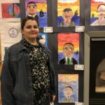 Students standing in front of their artwork.