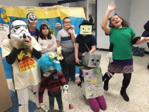 Students in costumes smile for the camera