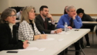 panelist watch as students give presentation