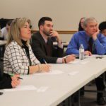 panelist watch as students give presentation