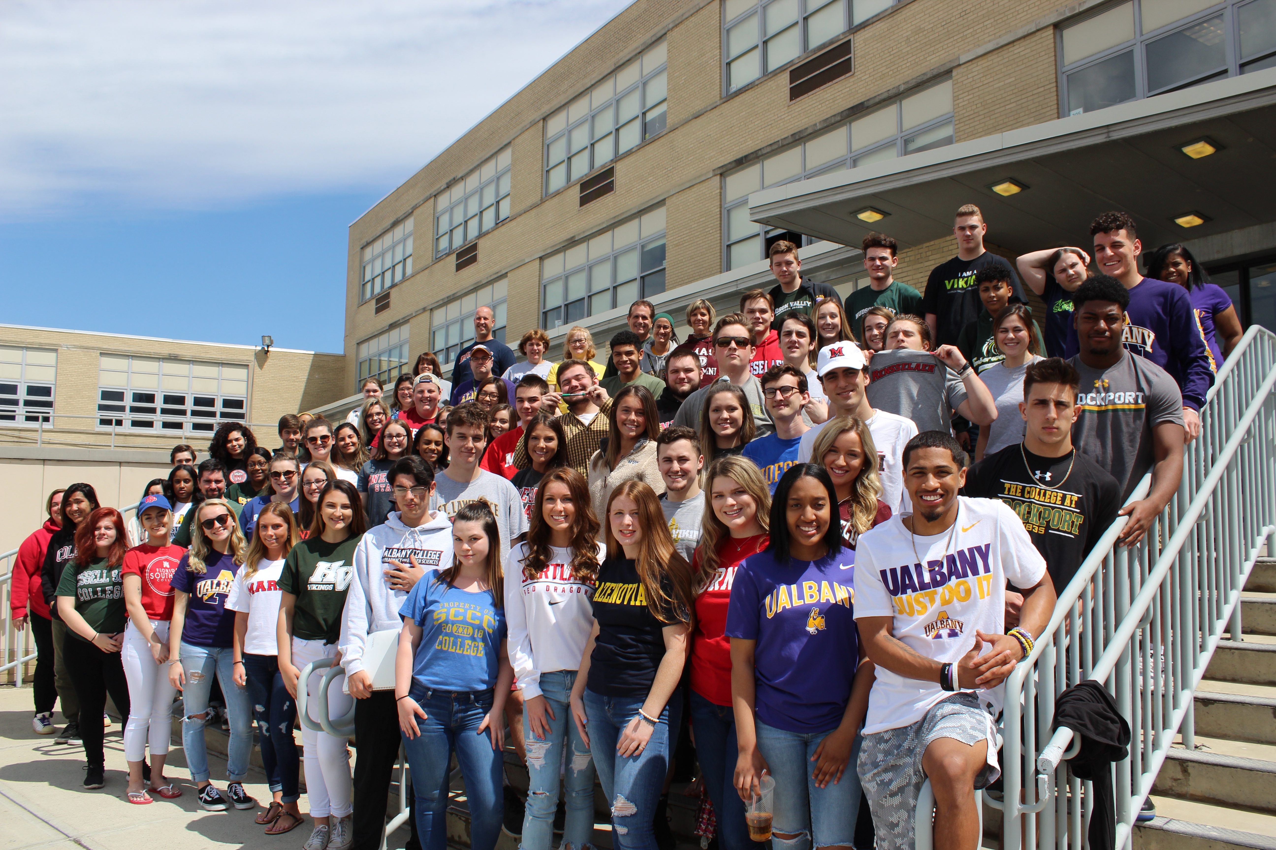 Group photo of seniors wearing their college shirts