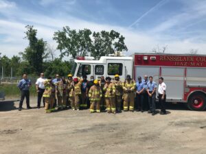 Students and firefighters in front of fire truck