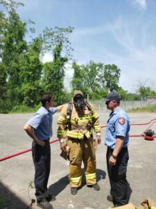 Firefighters and a student in fire gear