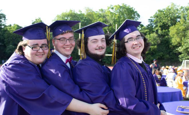 2021 students in yellow and purple cap and gown