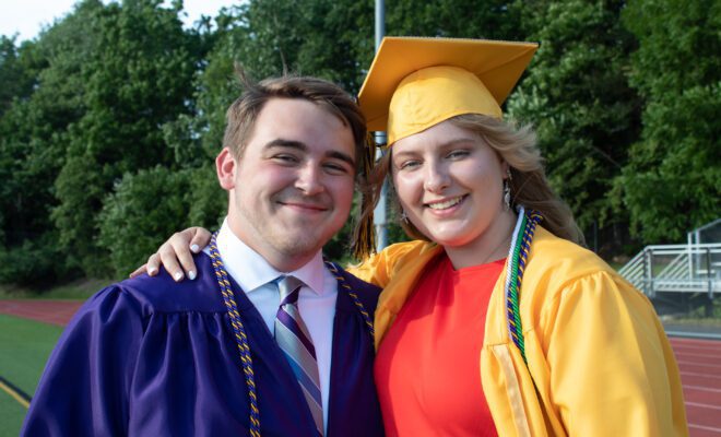 2021 students in yellow and purple cap and gown