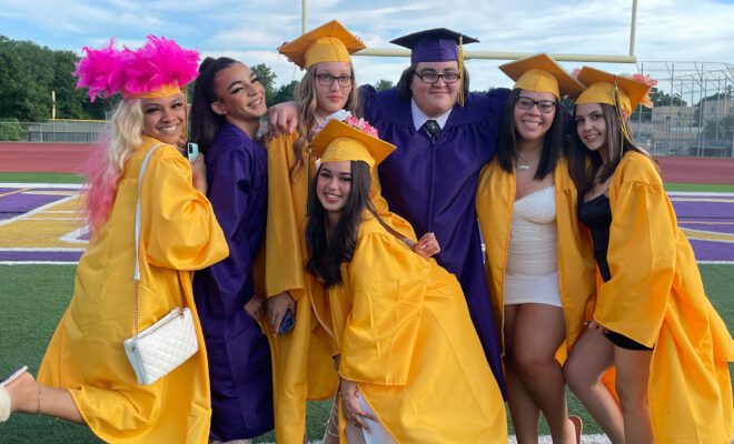 2021 students in yellow and purple cap and gown