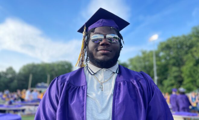 2021 students in yellow and purple cap and gown