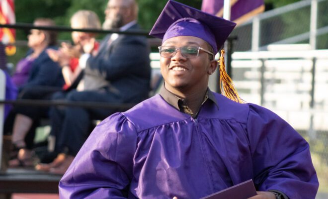 2021 students in yellow and purple cap and gown