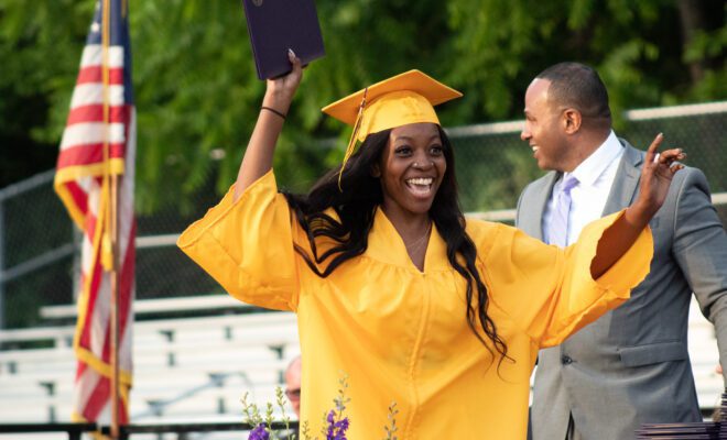 2021 students in yellow and purple cap and gown