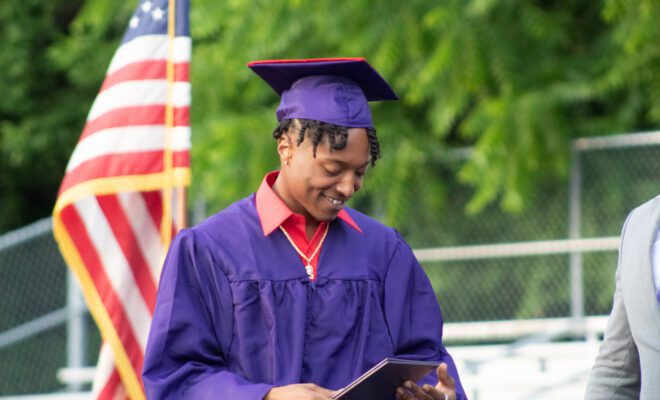 2021 students in yellow and purple cap and gown