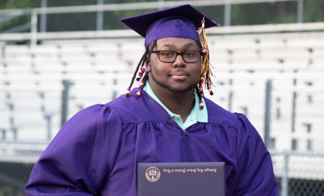 2021 students in yellow and purple cap and gown