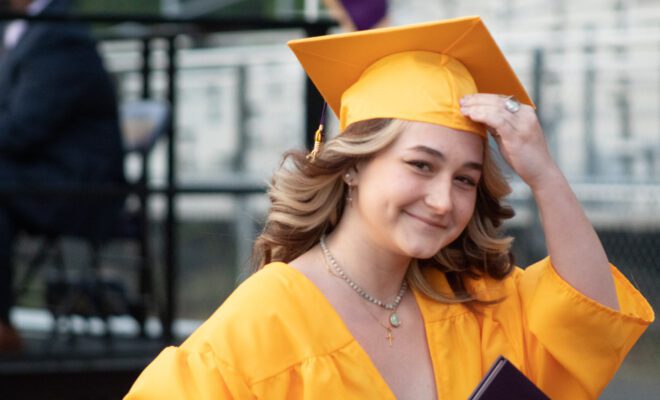 2021 students in yellow and purple cap and gown