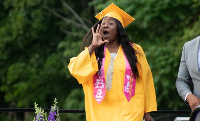 2021 students in yellow and purple cap and gown