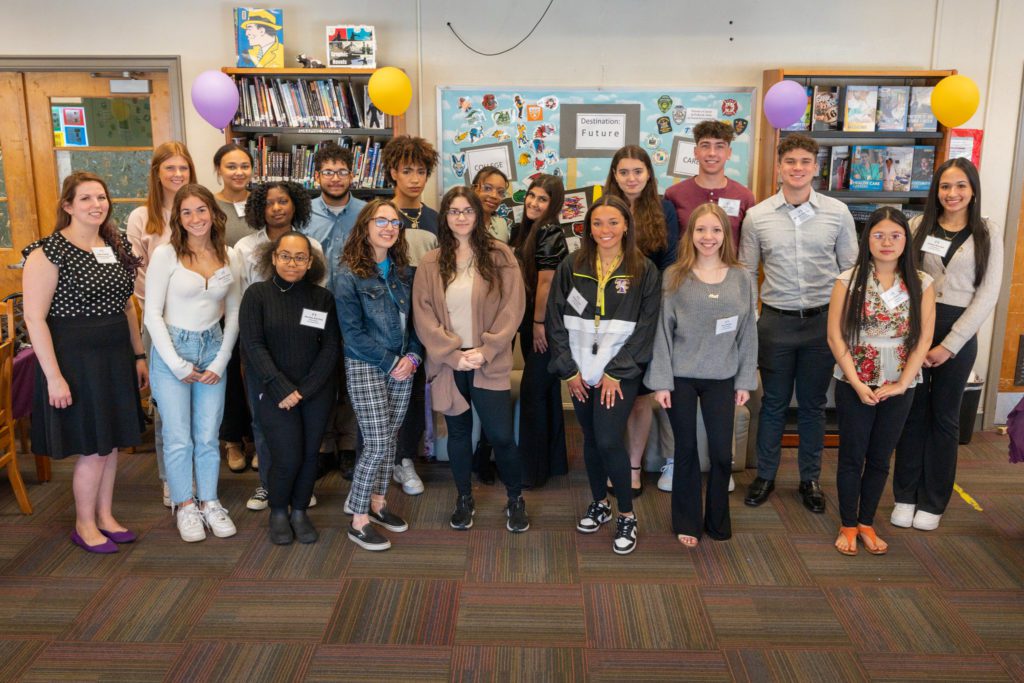 A group photo of 25 students in the troy high school library