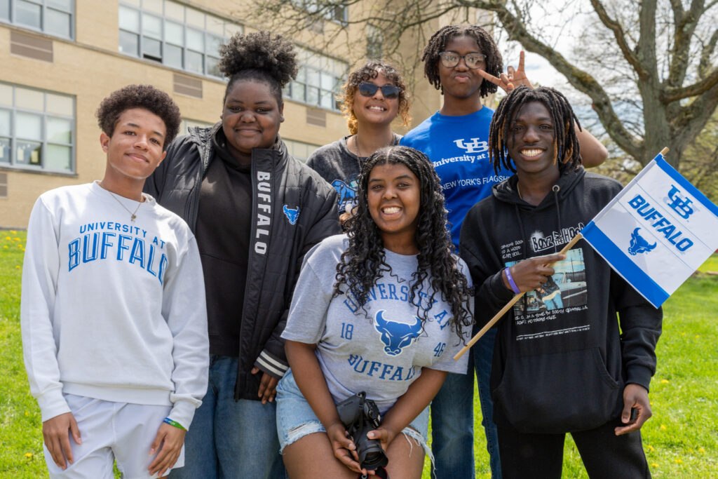 Troy High School seniors celebrate Decision Day in University at Buffalo gear, including a flag and spirit wear.